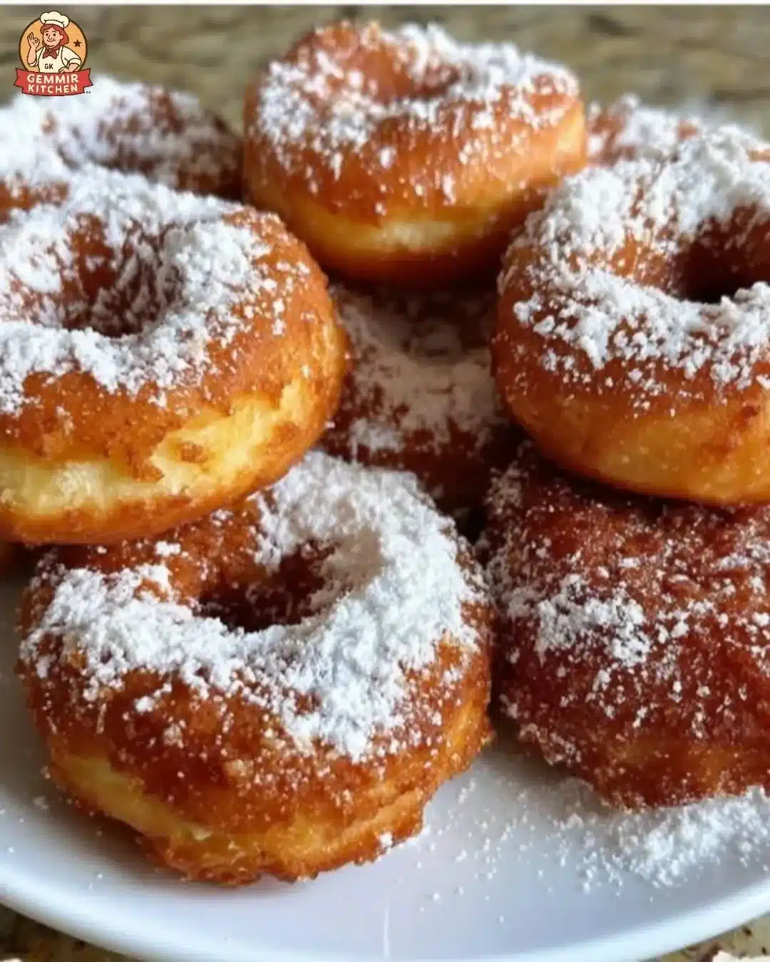 Crispy ricotta donuts topped with powdered sugar on a plate