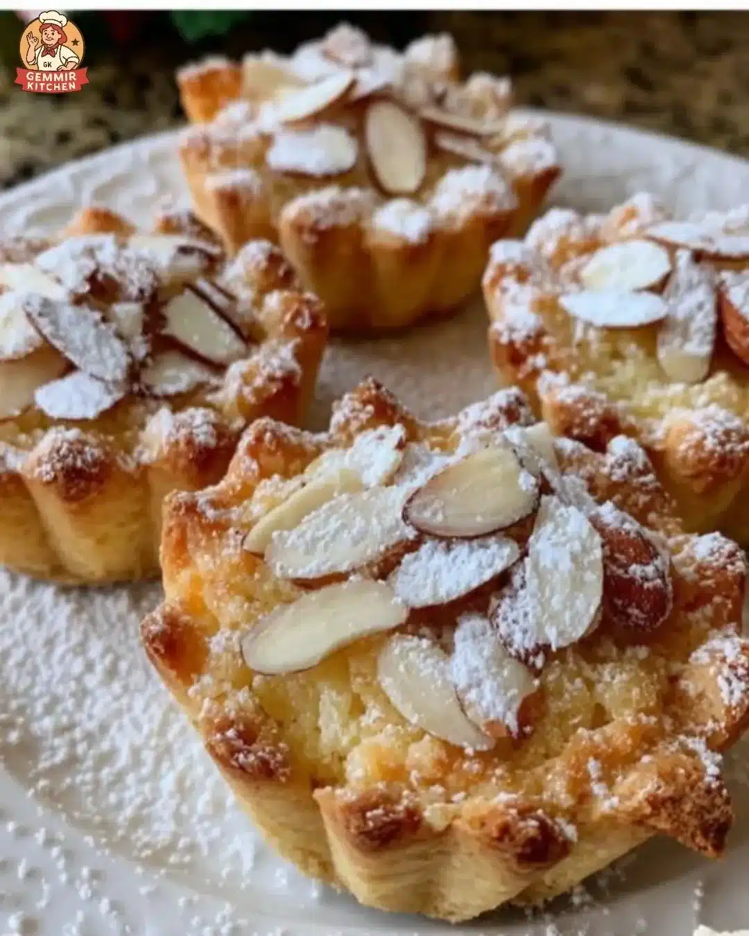 Mini Mascarpone Almond Tarts topped with slivered almonds and fresh fruit