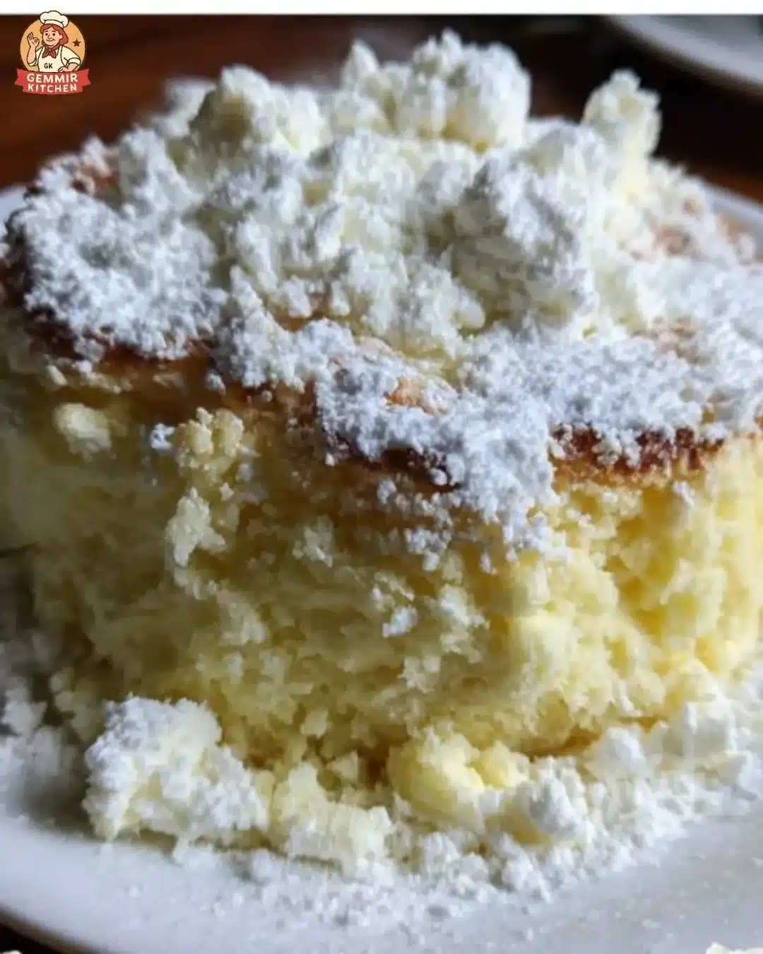 A slice of velvety Limoncello Ricotta Cloud Cake adorned with lemon zest.