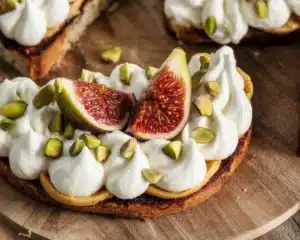 Toasted Pistachio Ricotta Wafers garnished with fresh pistachios and served on a platter.