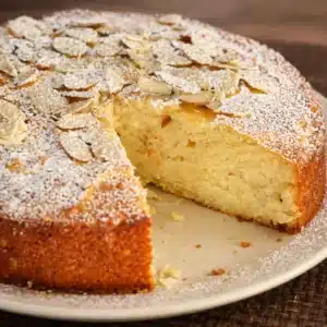 Espresso Almond Cake topped with Ricotta and Whipped Cream, beautifully decorated with almonds.