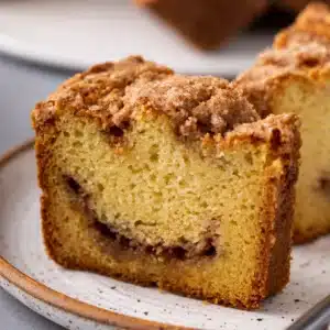 Slice of moist Sour Cream Coffee Cake with cinnamon streusel topping