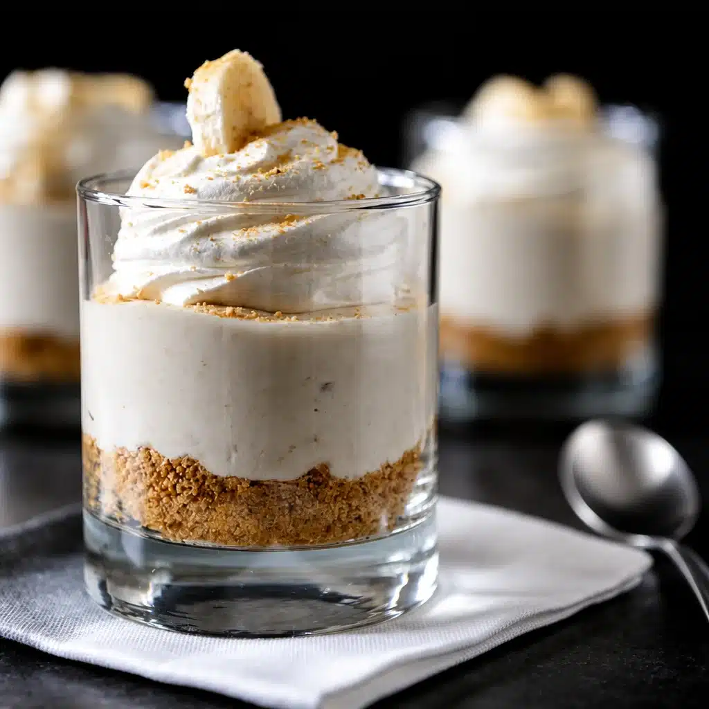Decadent No-Bake Banana Cheesecake Jars for Your Next Gathering 4 No-Bake Banana Cheesecake Jars served in mason jars, a perfect crowd-pleasing dessert.